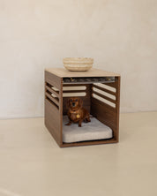 Pet bed with wooden crate furniture on a plain floor.