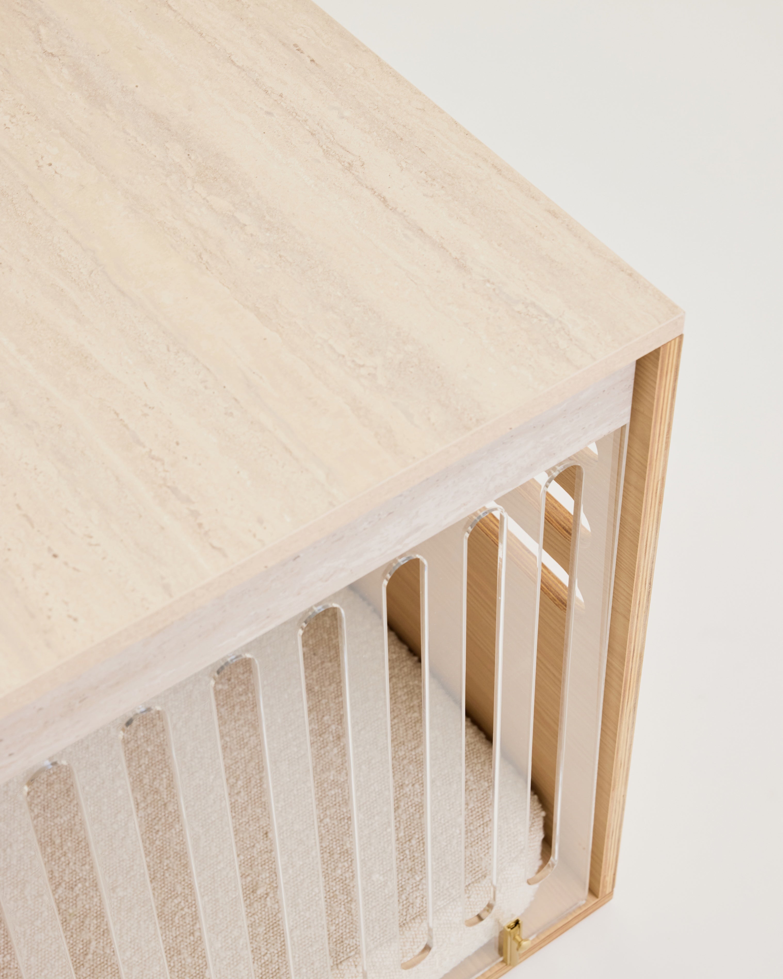 Wooden crib with a white mattress on a light background