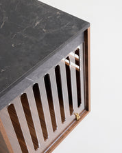 Marble countertop with a wooden base and decorative grille on a white background